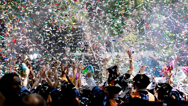 College graduates celebrate their accomplishments with a shower of colorful confetti